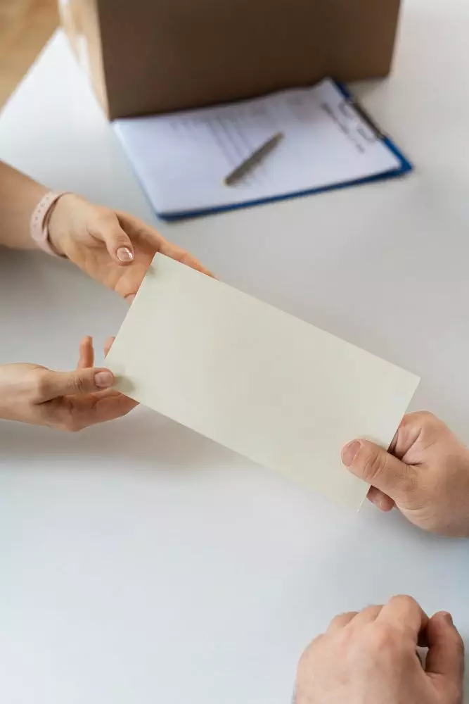 two people holding an envelope